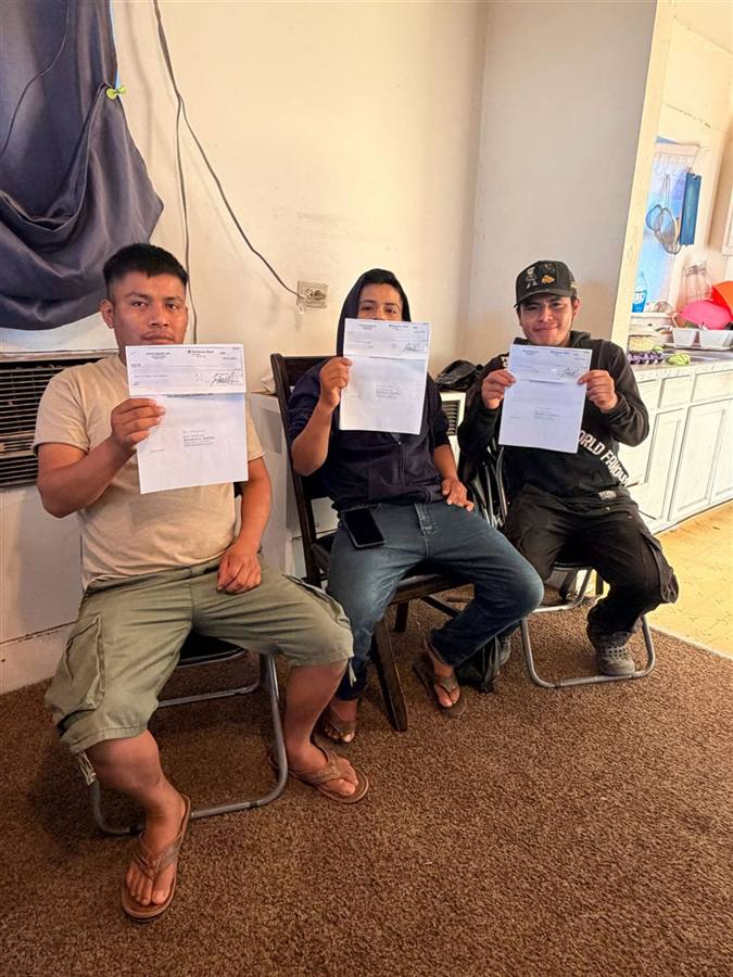 Fredy and his brothers holding their case documents