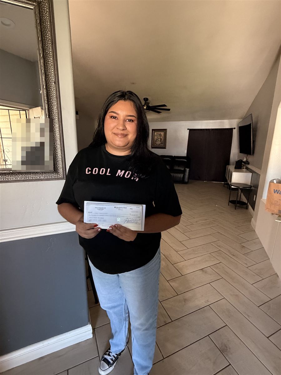 Juana at home holding her case documents